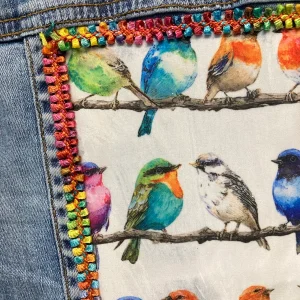 One of a kind, hand embellished upcycled denim jacket with colorful birds.
